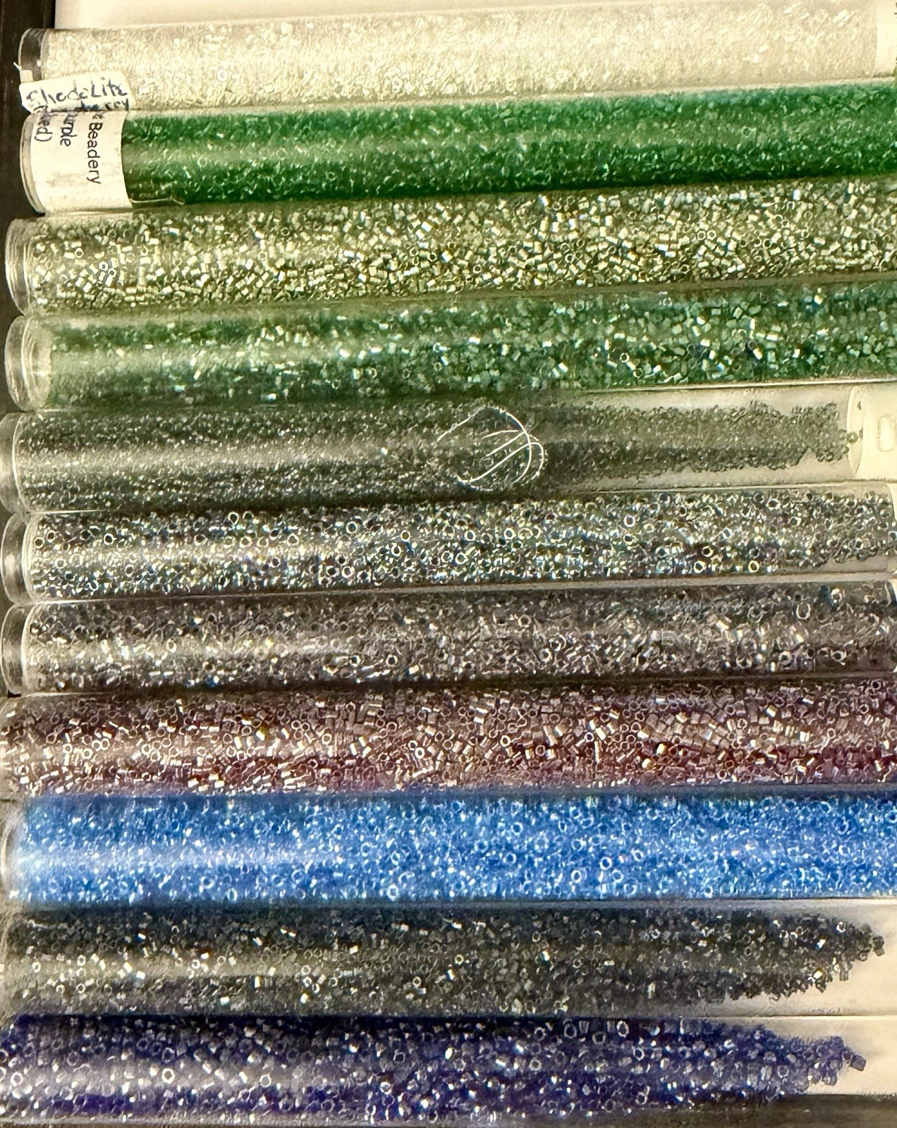 Collection of 11 Tubes of Assorted Metallic Seed Beads