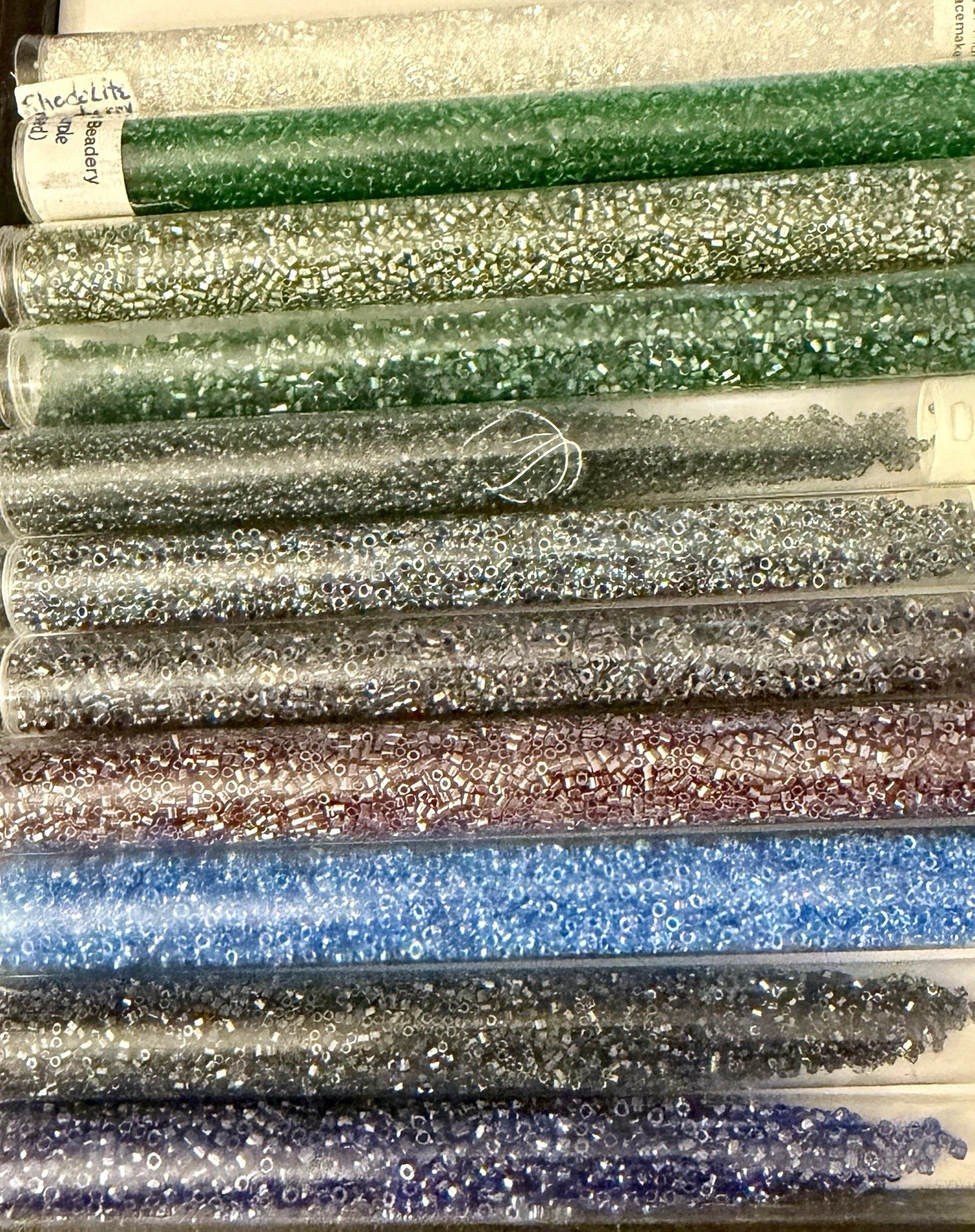 Collection of 11 Tubes of Assorted Metallic Seed Beads