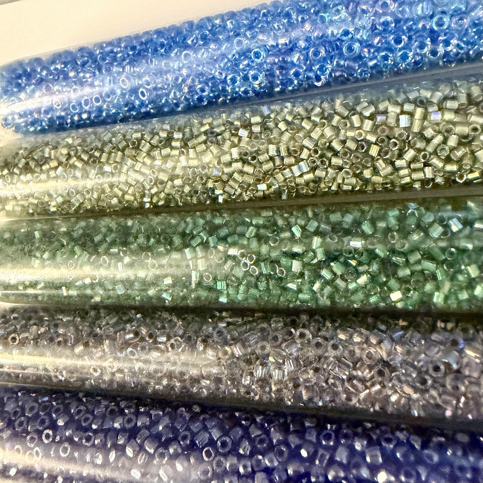 Collection of 11 Tubes of Assorted Metallic Seed Beads