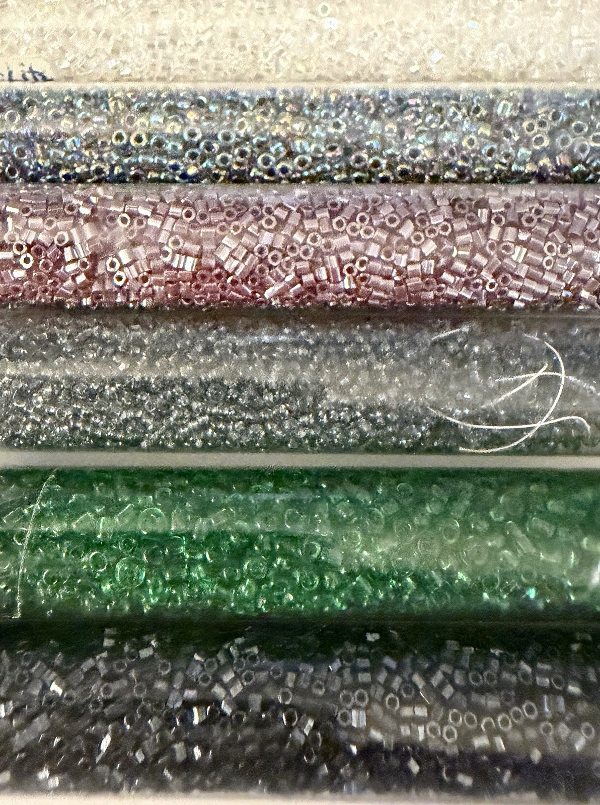 Collection of 11 Tubes of Assorted Metallic Seed Beads