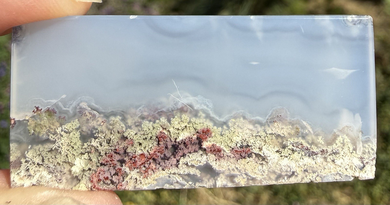 Plume Agate Cabochon. 1 3/4” x 3/4” x 1/8”, 0.3 ounce. Polished all sides.