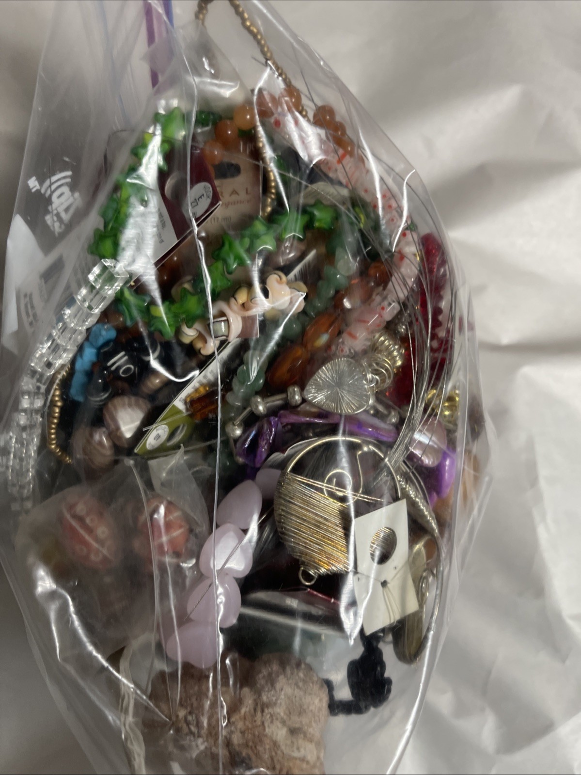Assortment Of Beads And Jewelry Making Products In A gallon Size Bag