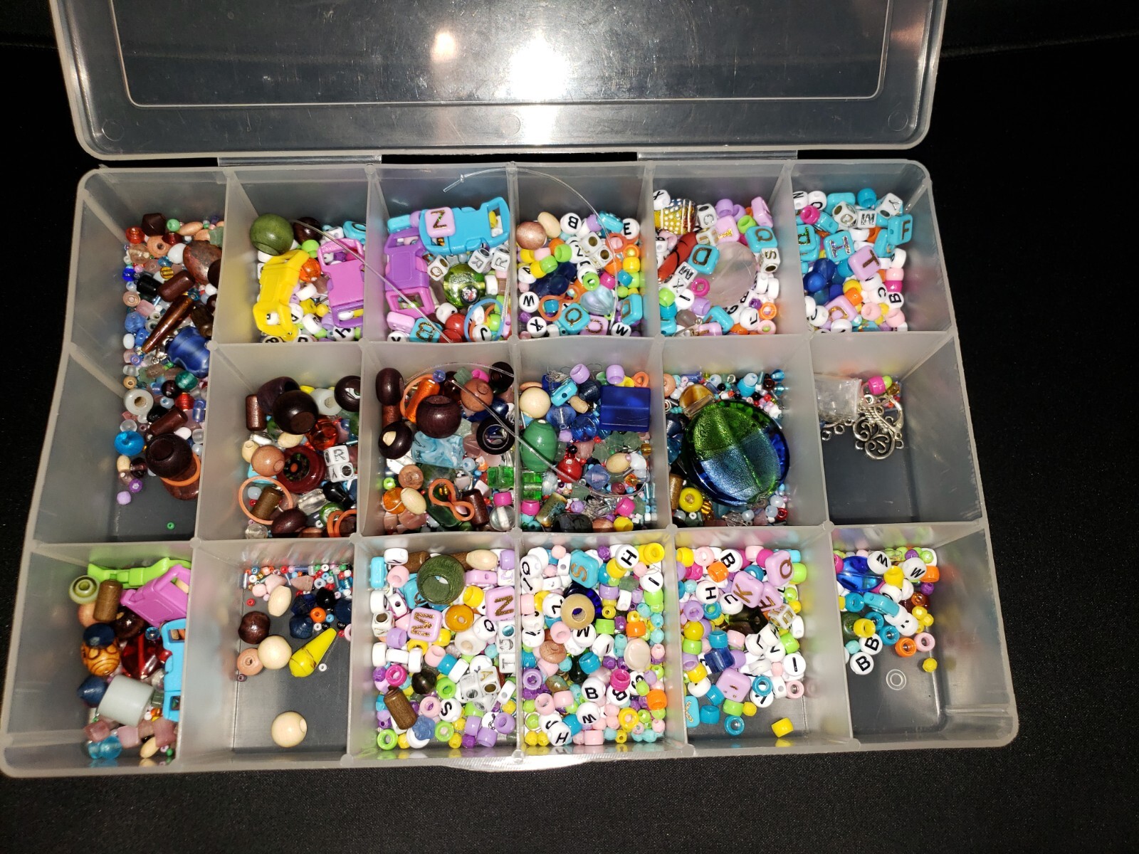 Lot of Assorted Beads, Letters, and More in container