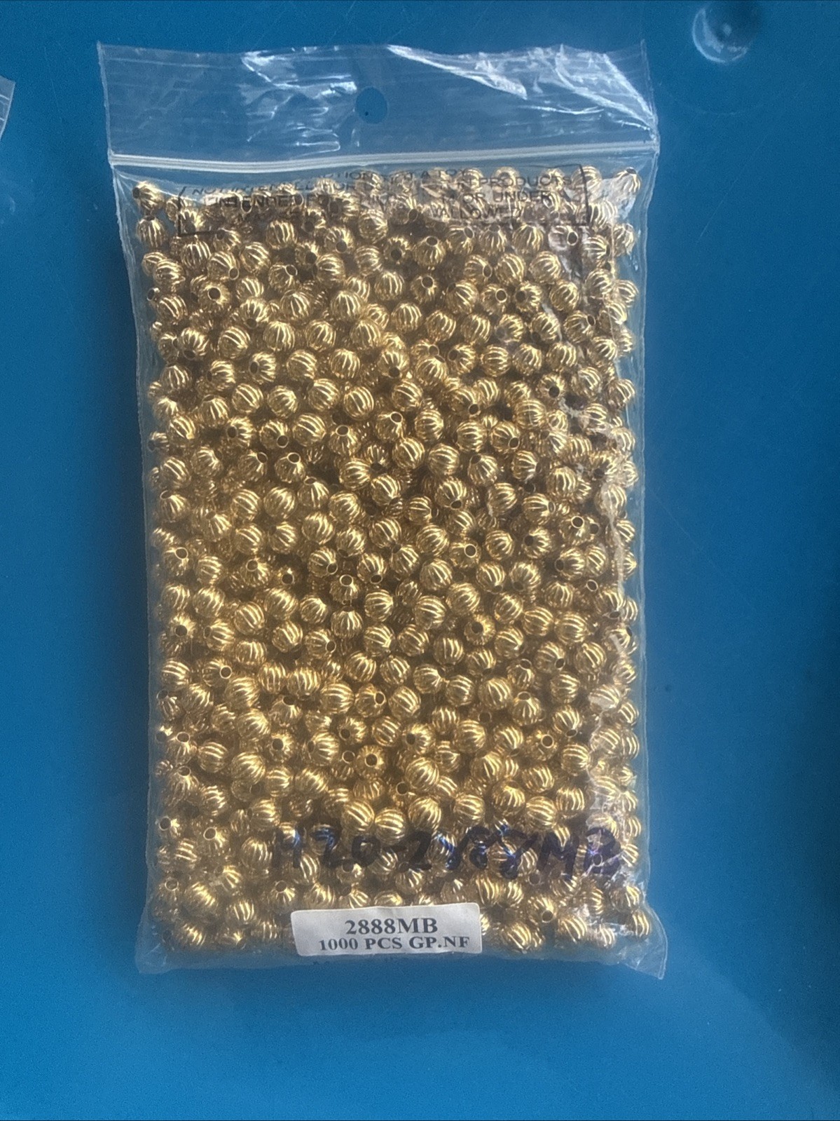 Fire mountain gems Bead 1pkg1000 gold-plated, 6mm corrugated round, brass